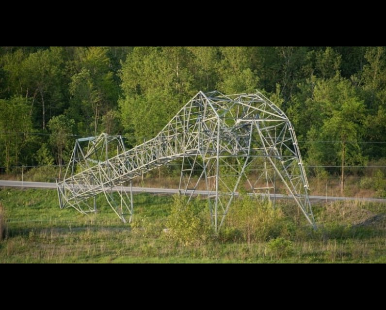 Hydro Ottawa shared this photo on social media showing a toppled Hydro One transmission tower near the Hunt Club Road exit off Highway 417. It's one of four towers Hydro One says were crumpled by storms that hit the area Saturday. (Hydro Ottawa/Twitter)