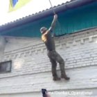 Ukrainian soldiers raise their flag in Kursk Oblast, Russia. 